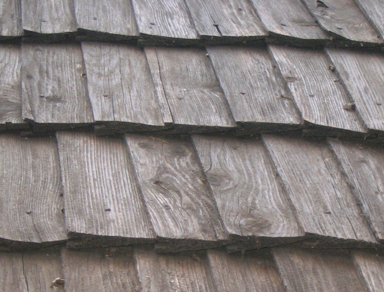 Close view of wood shingles showing the sawn faces and overlapping courses