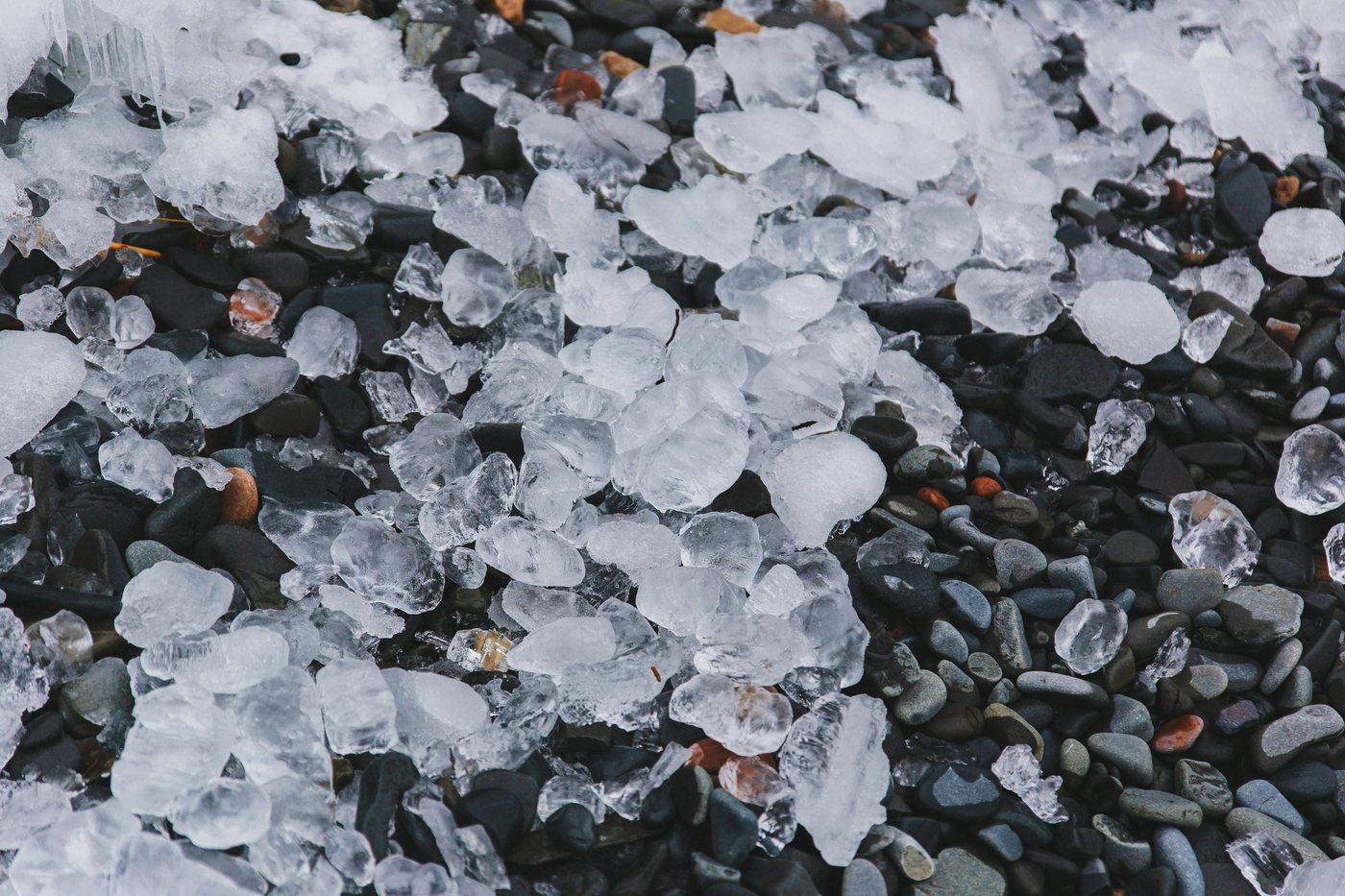 Hailstones scattered across a flat roof after a storm